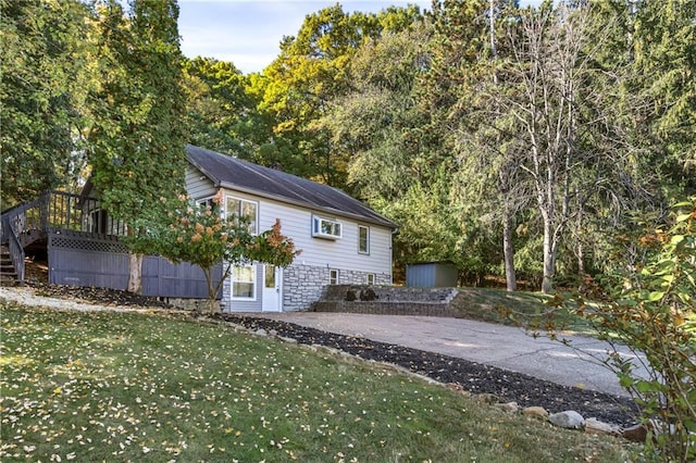 back of property featuring a patio area and a lawn