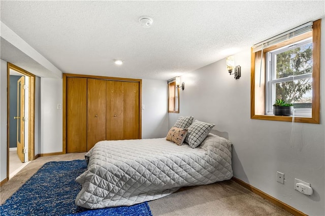 carpeted bedroom featuring a closet and a textured ceiling