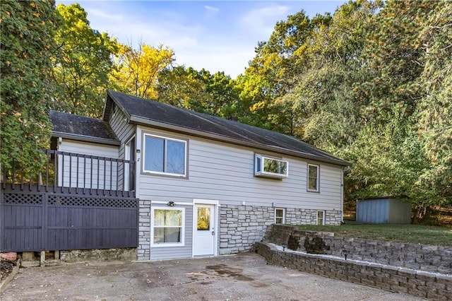 rear view of house featuring a shed and a patio area