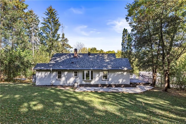 rear view of property featuring a patio area and a yard