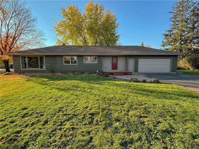 ranch-style house featuring a front yard and a garage