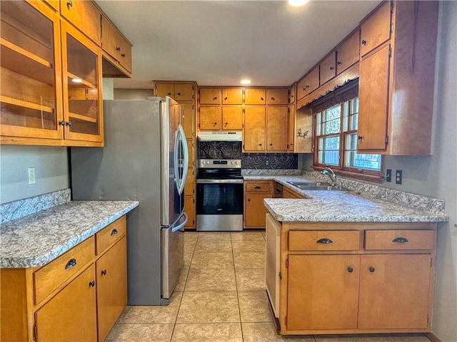 kitchen featuring light tile patterned floors, backsplash, stainless steel appliances, and sink