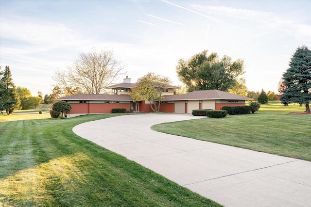 view of front of property featuring a garage and a front lawn