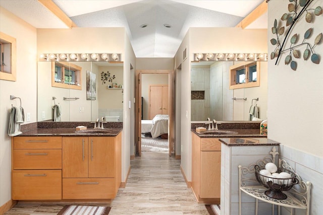 bathroom with vanity, hardwood / wood-style floors, walk in shower, and a textured ceiling