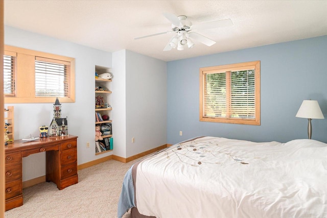 bedroom featuring multiple windows, light colored carpet, and ceiling fan