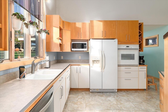 kitchen with white cabinetry, stainless steel appliances, and sink