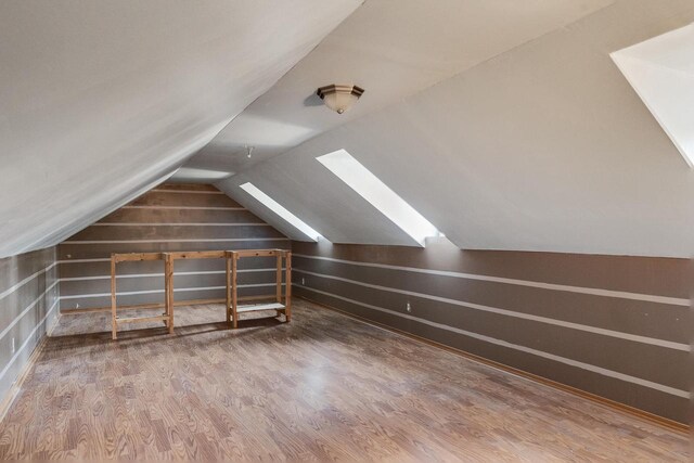 bonus room featuring lofted ceiling and hardwood / wood-style flooring