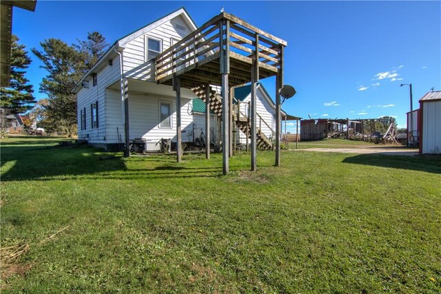 exterior space with a yard, stairway, and a wooden deck