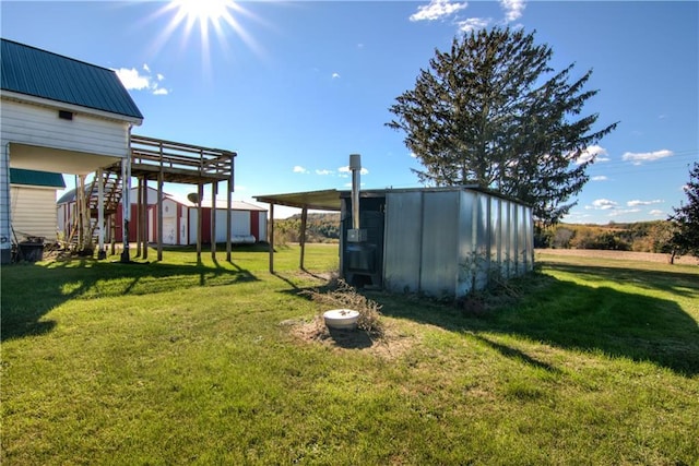 view of yard with a shed, stairs, and an outdoor structure