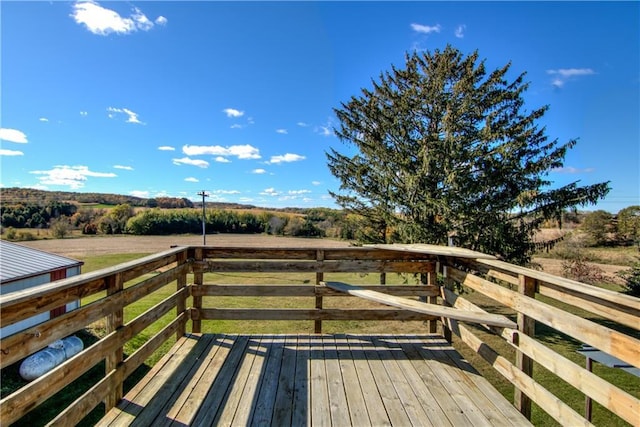 wooden deck with a rural view