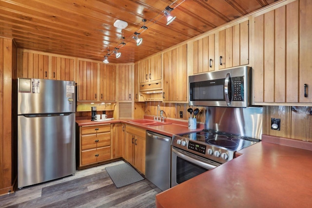 kitchen featuring track lighting, hardwood / wood-style flooring, wooden ceiling, sink, and stainless steel appliances