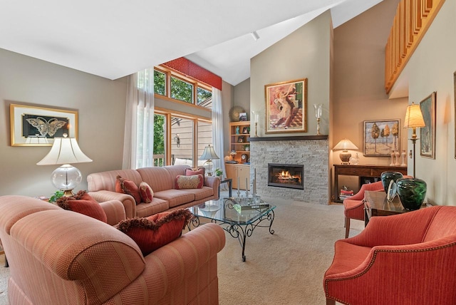 living room with carpet, a stone fireplace, and high vaulted ceiling