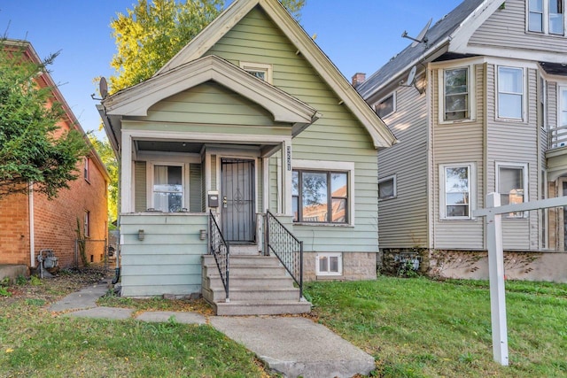 bungalow-style home with a front lawn