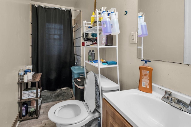 bathroom with vanity, toilet, a shower with shower curtain, and hardwood / wood-style floors