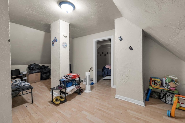 3221 N 38th St, Milwaukee, WI 53216 - bonus room with a textured wall, wood finished floors, a textured ceiling, and vaulted ceiling