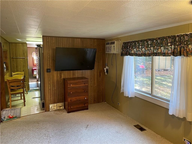 carpeted bedroom featuring wooden walls, a wall mounted AC, and a textured ceiling