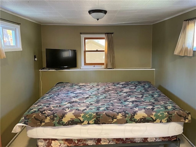 bedroom with crown molding and multiple windows