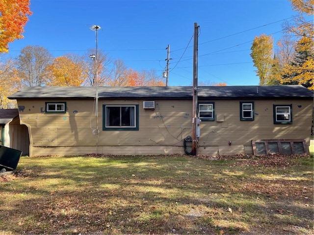 rear view of house featuring a lawn