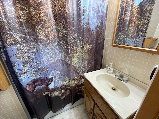 bathroom with vanity and tile walls