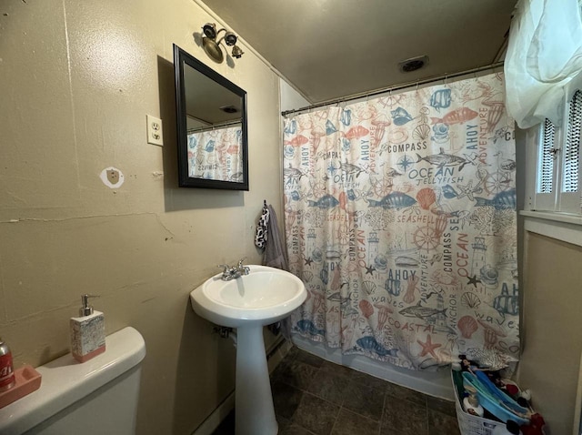 bathroom with toilet and shower / tub combo with curtain