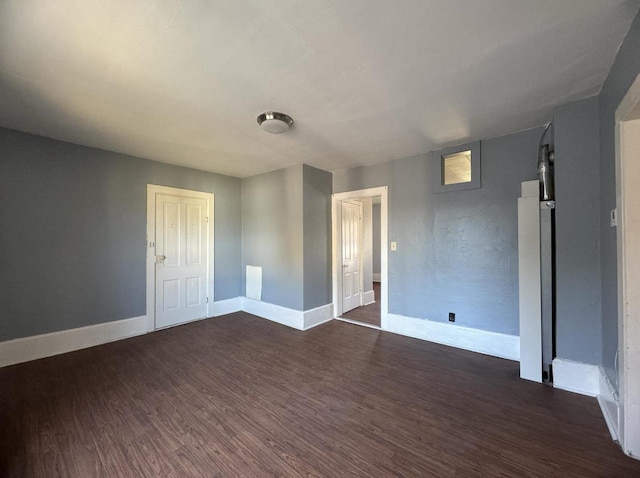 spare room featuring dark hardwood / wood-style floors