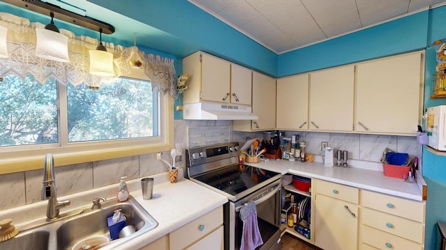 kitchen with sink, decorative backsplash, decorative light fixtures, and stainless steel range with electric cooktop