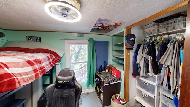 bedroom with crown molding and a closet