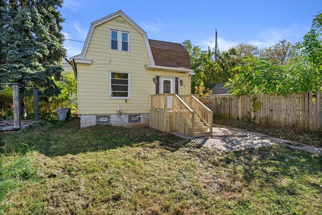 rear view of house with a yard