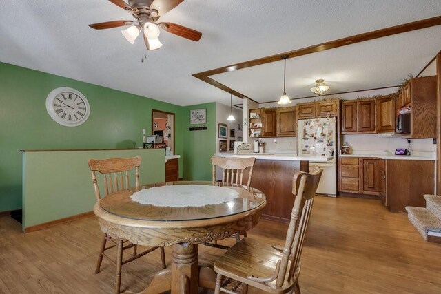 26314 276th St, Holcombe, WI 54745 - dining space featuring a ceiling fan, baseboards, and light wood-type flooring