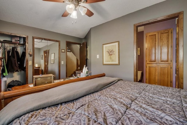 bedroom featuring ceiling fan and multiple closets