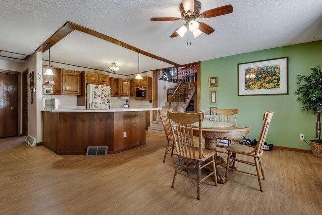 26314 276th St, Holcombe, WI 54745 - dining space featuring visible vents, light wood-style floors, baseboards, a ceiling fan, and stairs