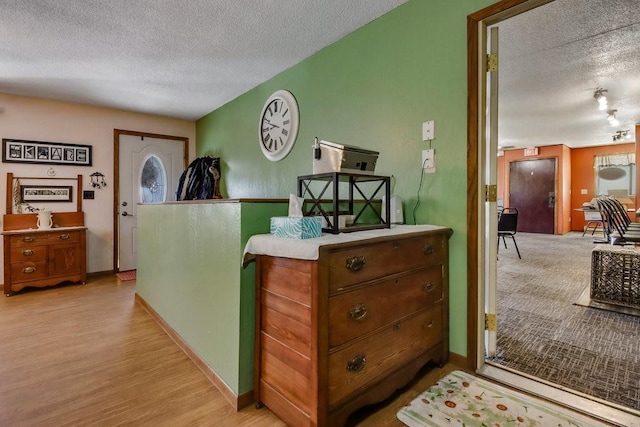 26314 276th St, Holcombe, WI 54745 - interior space featuring a textured ceiling, light wood-style floors, and baseboards