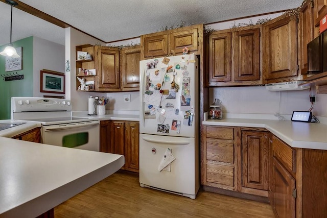 kitchen featuring hanging light fixtures, a textured ceiling, light wood-type flooring, crown molding, and white appliances