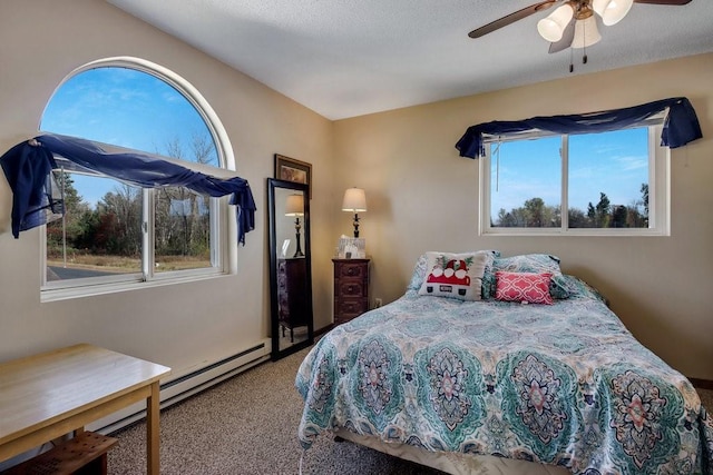 carpeted bedroom featuring ceiling fan, a textured ceiling, and a baseboard radiator