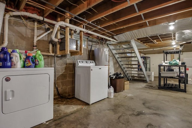 basement with water heater and washer and clothes dryer