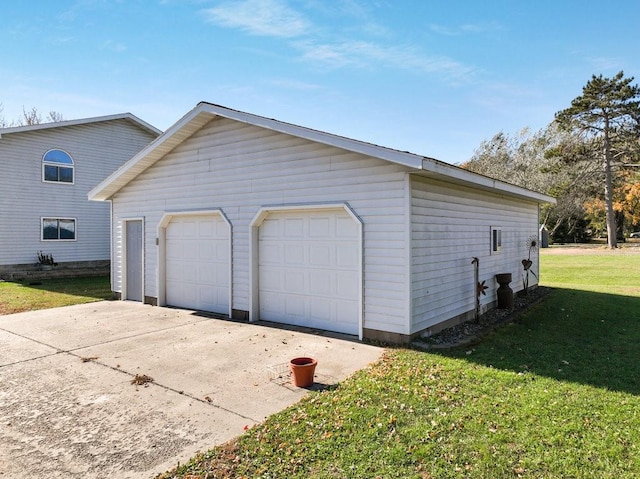 garage featuring a lawn