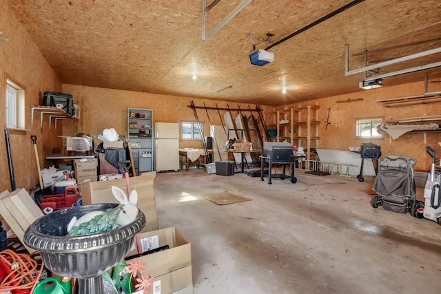 garage with a garage door opener and white fridge