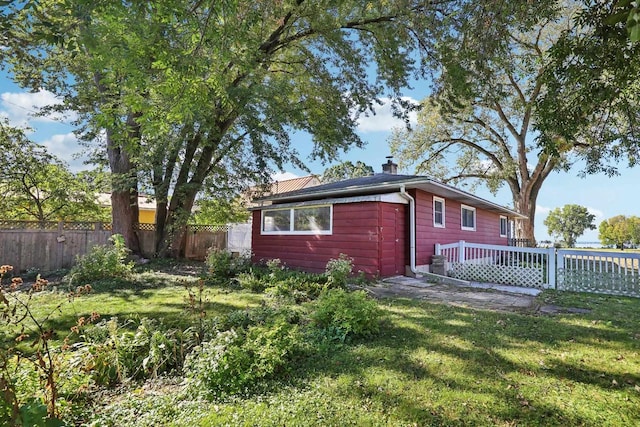 rear view of house with a yard