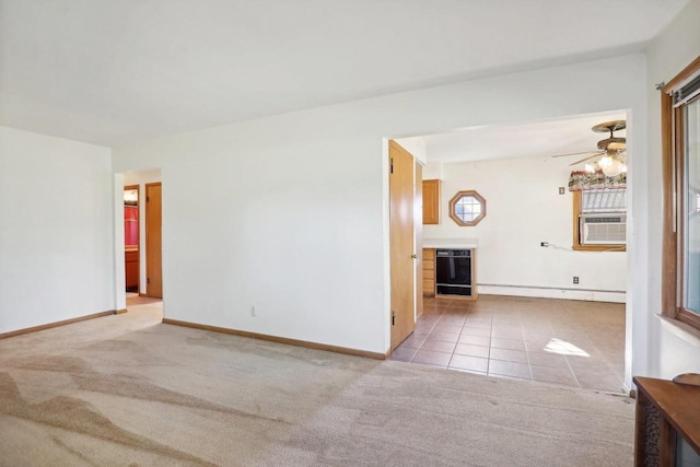 carpeted spare room with wine cooler, cooling unit, and ceiling fan