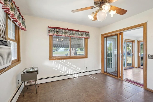 tiled empty room with baseboard heating and ceiling fan