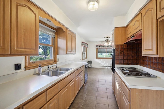 kitchen featuring dark tile patterned flooring, sink, white gas stovetop, ceiling fan, and decorative backsplash