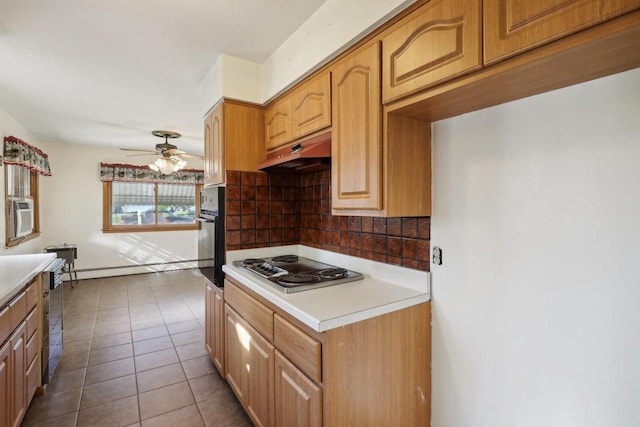 kitchen with ceiling fan, tasteful backsplash, appliances with stainless steel finishes, and dark tile patterned floors