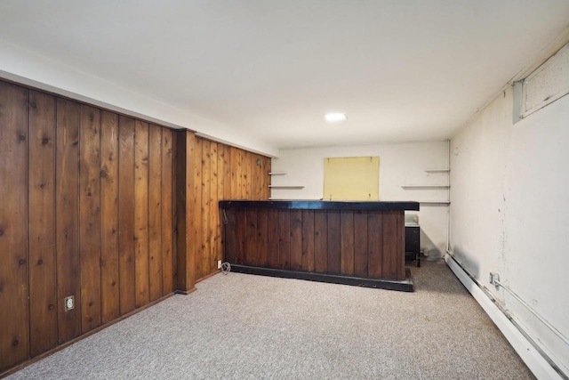 bar featuring wood walls, a baseboard heating unit, and carpet