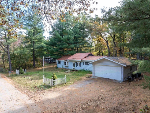 view of front of property with a front yard and a garage