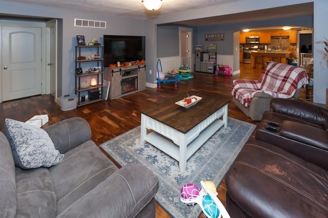 living room with dark hardwood / wood-style floors