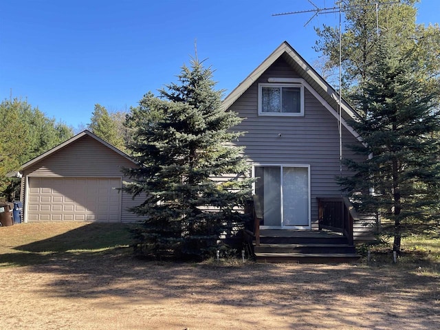 back of property featuring an outbuilding and a garage