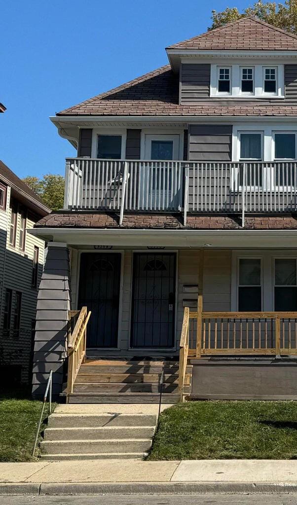 view of front of property with a porch and a balcony
