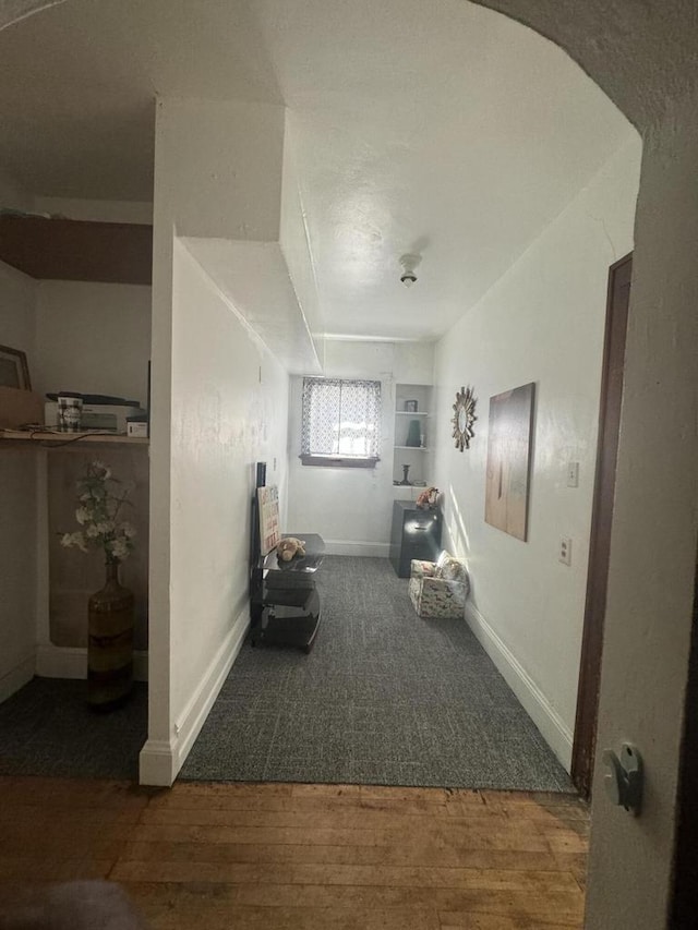 interior space with baseboards and wood finished floors