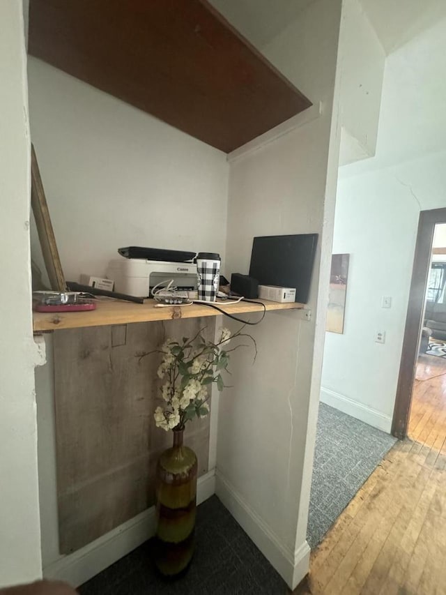 interior details featuring wood finished floors and baseboards