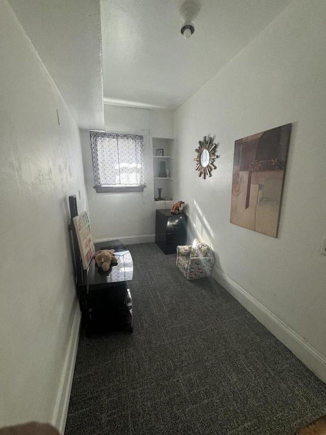 unfurnished room with dark carpet